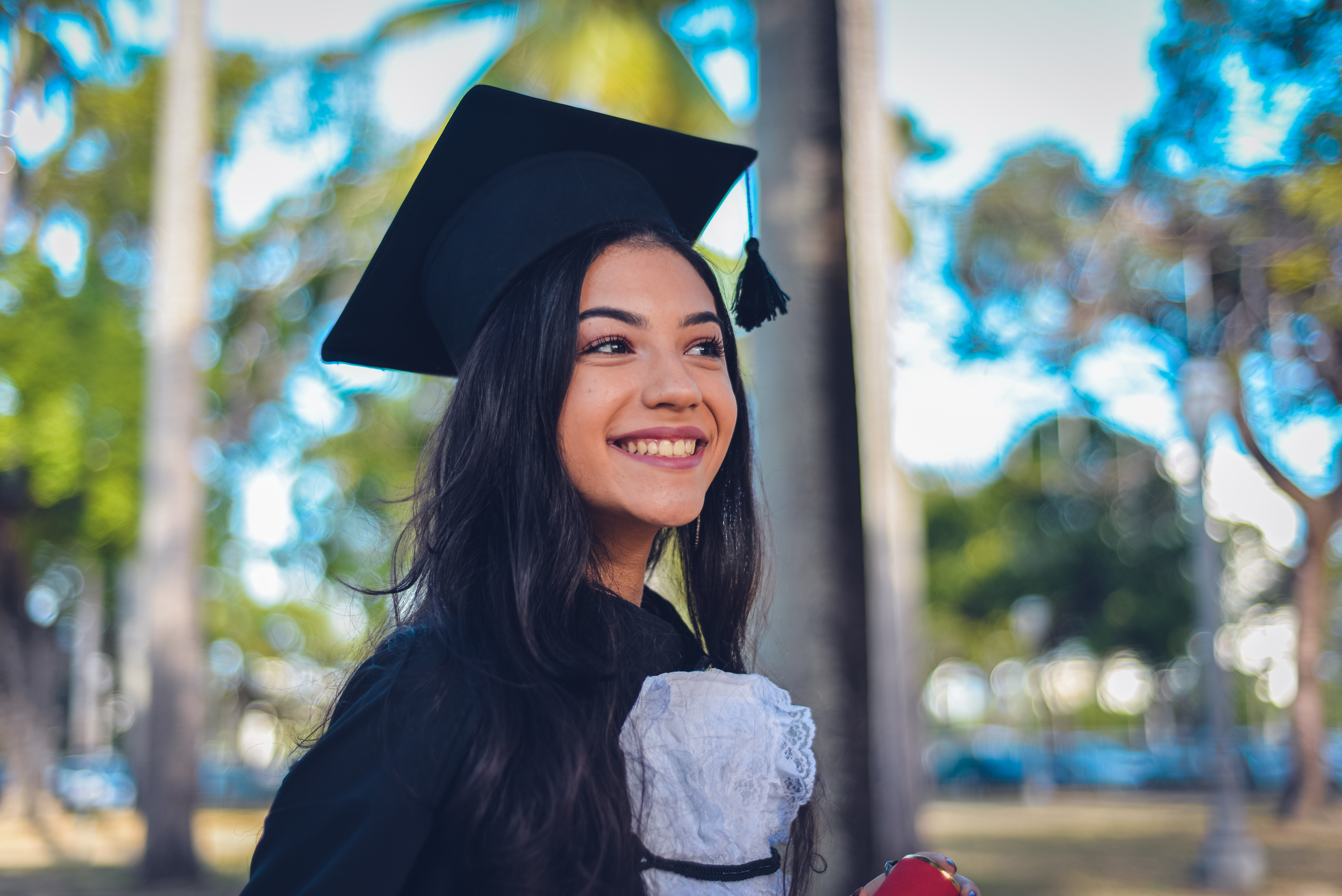 Smiling graduate in cap and gown